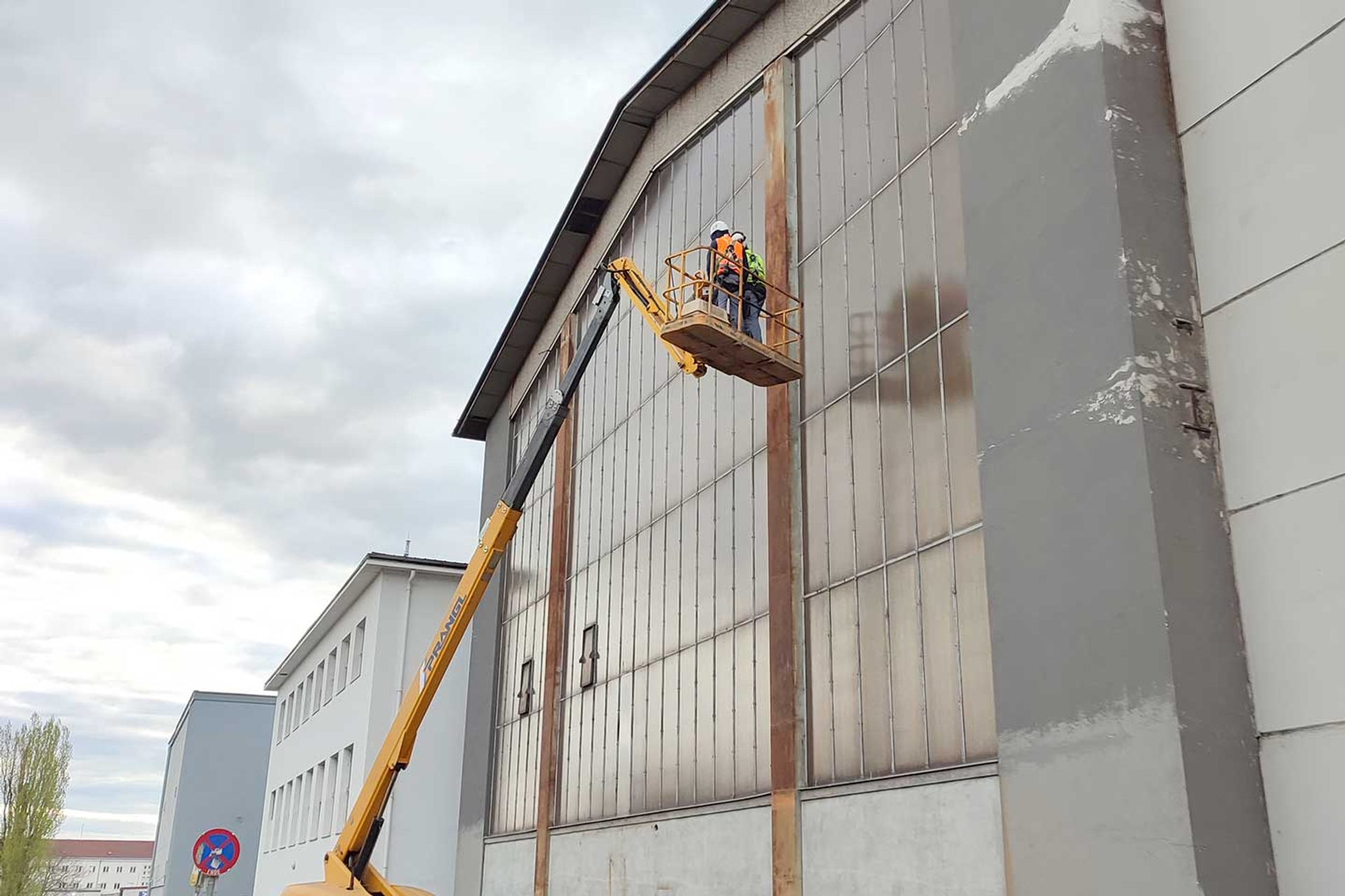 Hebebühne hebt 2 Männer zu den Falkennestern an der VOITH-Halle