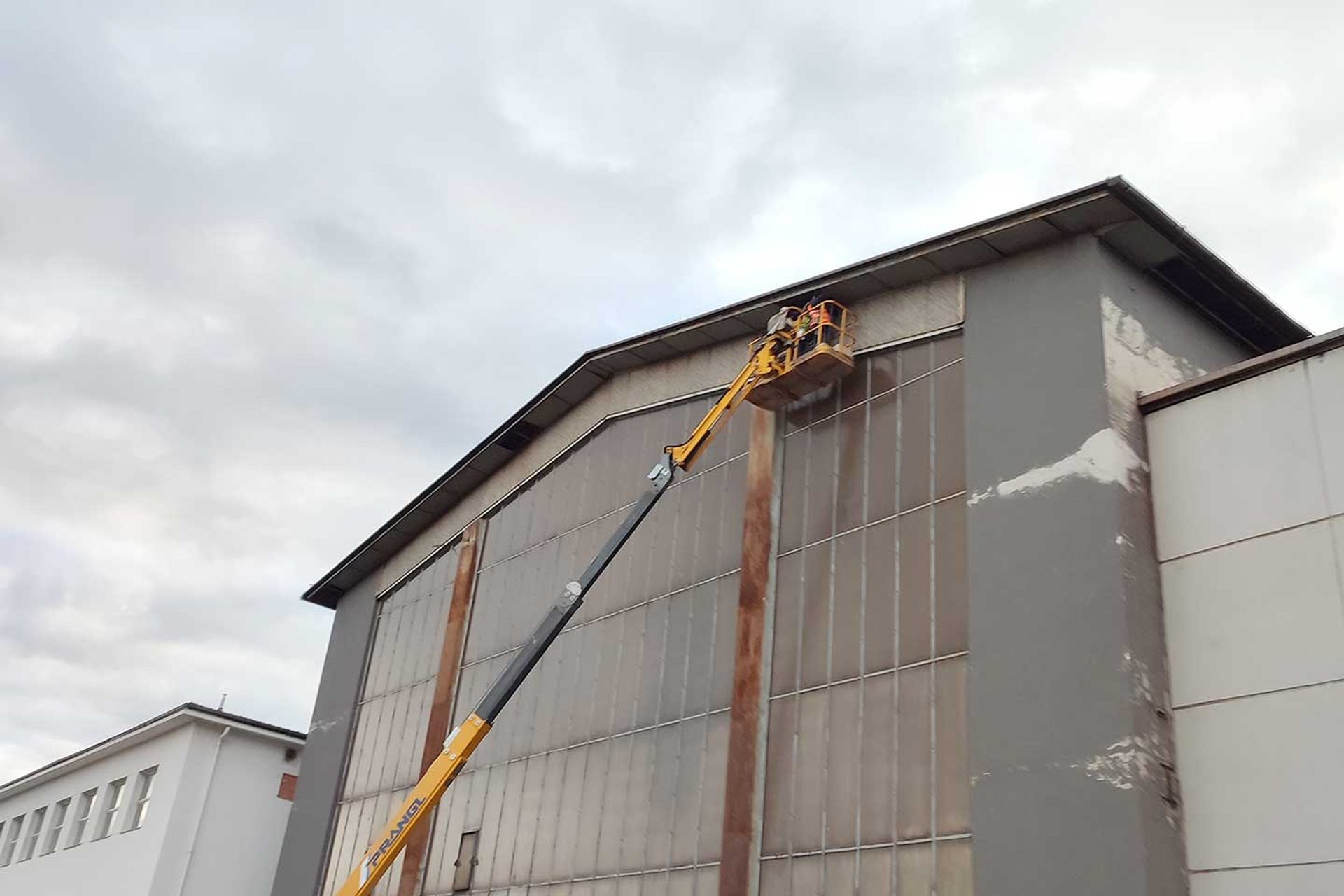 Hebebühne hebt 2 Männer zu den Falkennestern an der VOITH-Halle