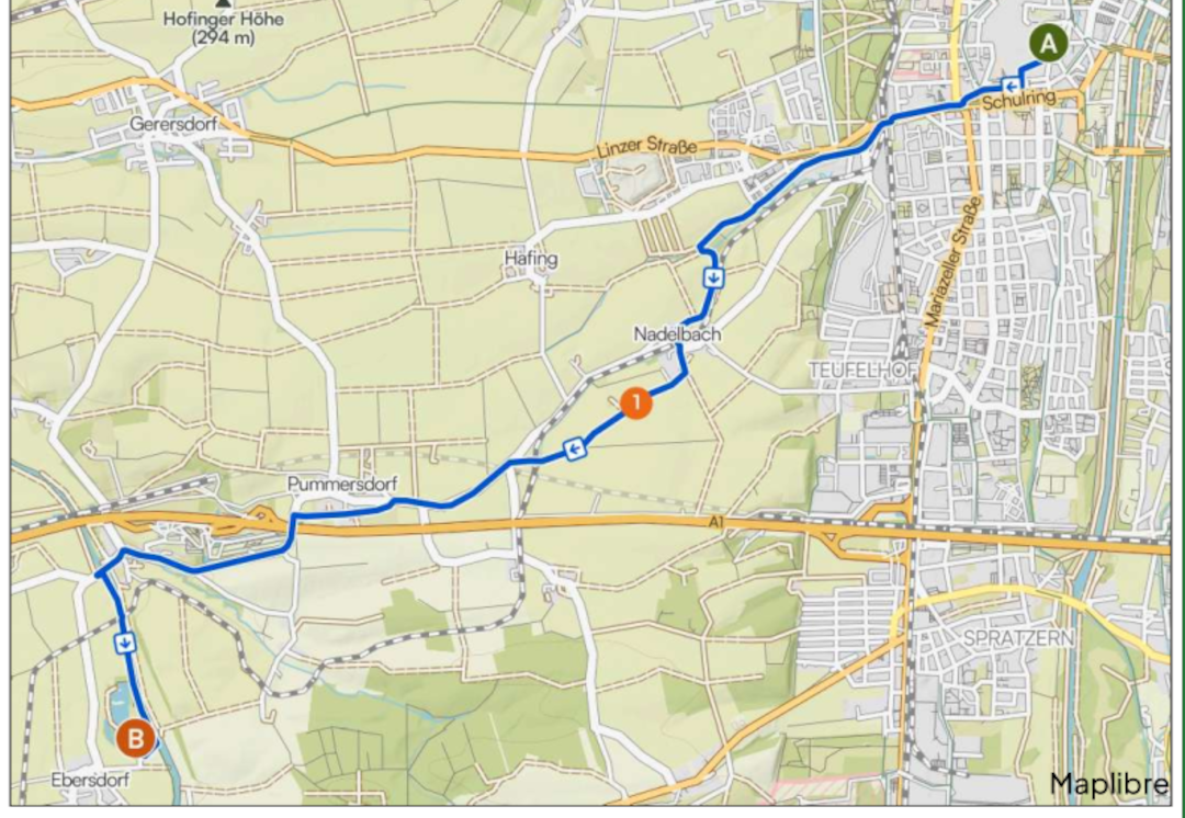 Kartenausschnitt mit eingezeichneter Radroute von St. Pölten zum Ebersdorfer See. Die Route startet rechts oben beim Markierungspunkt A in St. Pölten, Bereich Schulring, führt westlich aus der Stadt hinaus, weiter über bzw. nahe Nadelbach und Pummersdorf und endet links unten beim Markierungspunkt B beim Ebersdorfer See. Die Strecke ist als blaue Linie auf einer Straßen- und Umgebungskarte dargestellt.